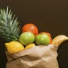A grocery bag full of fruit.