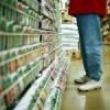 Someone standing in the isle of a garden center.