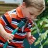 Child drinking water from a hose.