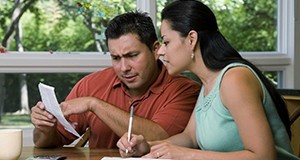 A couple looking over their utility bills.