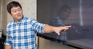 A student instructing in a conference room.